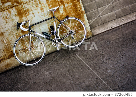 Rusted iron door and black road bike Rusted iron door and black road bike 87203495