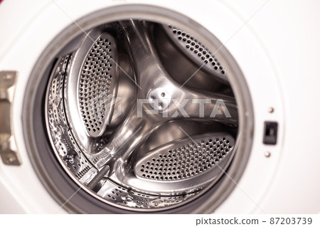 The washing machine drum is dry and clean close-up. Washer 87203739