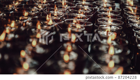 Detail of Many red votive candles light with shallow depth of field inside Chinese temple. Detail of Many red votive candles light with shallow depth of field inside Chinese temple. 87204228