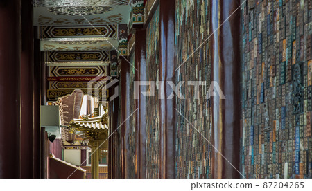 Architecture of Golden gable roof and slab of colored tiles on temple wall at Fo Guang San Temple. 87204265