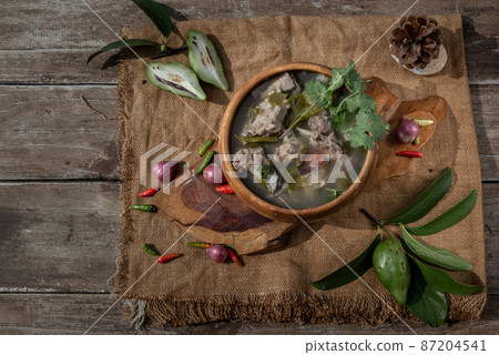 Pork spare rip Madan soup (Kra Dook Moo Tom Ma-Dun) in a Wooden bowl, Traditional Thai food. bowl, Traditional Thai food. Pork spare rip Madan soup (Kra Dook Moo Tom Ma-Dun) in a Wooden bowl, Traditional Thai food. bowl, Traditional Thai food. 87204541