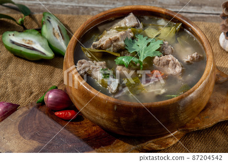 Pork spare rip Madan soup (Kra Dook Moo Tom Ma-Dun) in a wooden bowl, Traditional Thai food. Pork spare rip Madan soup (Kra Dook Moo Tom Ma-Dun) in a wooden bowl, Traditional Thai food. 87204542
