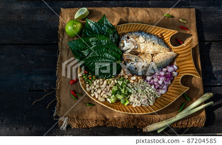 Thai Traditional Food : Fried mackerel served with fresh vegetable and herb, This food is thai food call Meuang Mackerel (Maing-Pla-too) menu. Thai Traditional Food : Fried mackerel served with fresh vegetable and herb, This food is thai food call Meuang Mackerel (Maing-Pla-too) menu. 87204585