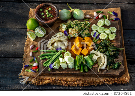 Thai Traditional Local Food : Spicy Shrimp Paste Dip or Fried shrimp paste sauce (Nam Prik Kapi) with blanched vegetables and cha-om omelets on wooden backgroud. Thai Traditional Local Food : Spicy Shrimp Paste Dip or Fried shrimp paste sauce (Nam Prik Kapi) with blanched vegetables and cha-om omelets on wooden backgroud. 87204591
