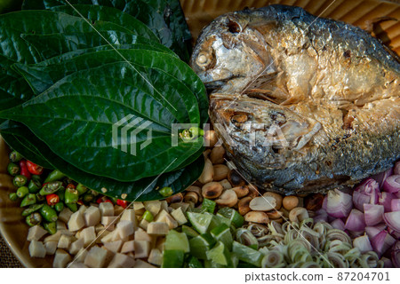 Thai Traditional Food : Fried mackerel served with fresh vegetable and herb, This food is thai food call Meuang Mackerel (Maing-Pla-too) menu. Thai Traditional Food : Fried mackerel served with fresh vegetable and herb, This food is thai food call Meuang Mackerel (Maing-Pla-too) menu. 87204701