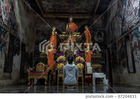 Young woman sitting praying pay respect to Buddha statue in the .Wat Kongkharam Rajavaravihara (Photharam) Ratchaburi. Worship pray Young woman sitting praying pay respect to Buddha statue in the .Wat Kongkharam Rajavaravihara (Photharam) Ratchaburi. Worship pray 87204831