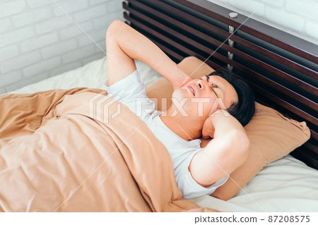 Man in the bedroom (ear hurts) 87208575