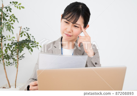 Business woman explaining while reading documents Business woman explaining while reading documents 87208893