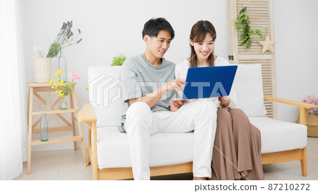 Young men and women using laptops Young men and women using laptops 87210272