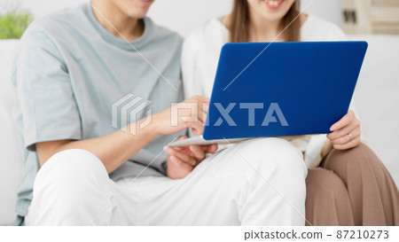 Young men and women using laptops Young men and women using laptops 87210273