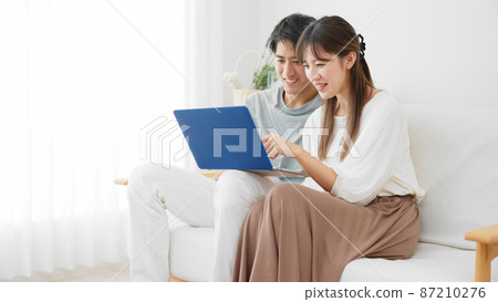 Young men and women using laptops Young men and women using laptops 87210276