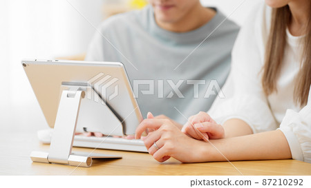 Young men and women using tablet computers Young men and women using tablet computers 87210292