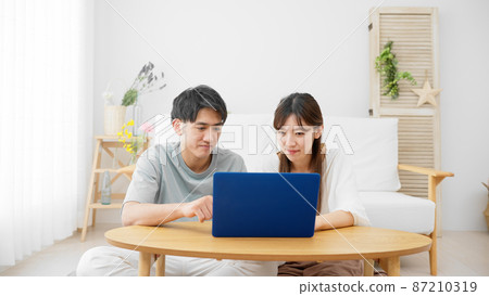 Young men and women looking at laptops Young men and women looking at laptops 87210319