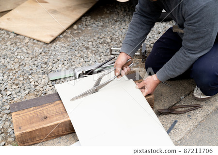 Sheet metal shop working at a wooden construction site Sheet metal shop working at a wooden construction site 87211706