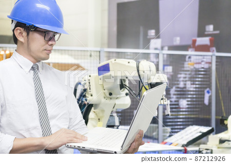 The engineer use notebook setup program for robotic in material handling system . The engineer use notebook setup program for robotic in material handling system . 87212926