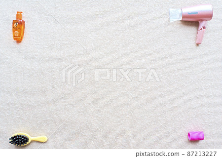 A miniature of shampoo on the upper left, brush on the lower left, hair dryer on the upper right and curlers on the lower right 87213227