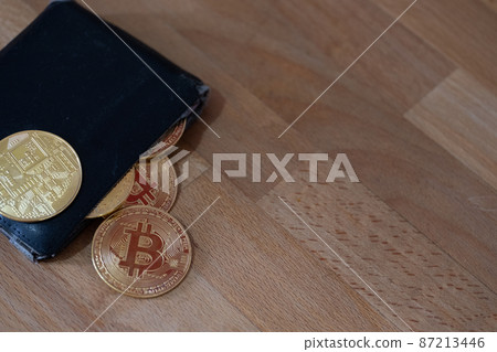 Bitcoins and crypto currency wallet close up and copy space Bitcoins and crypto currency wallet close up and copy space 87213446