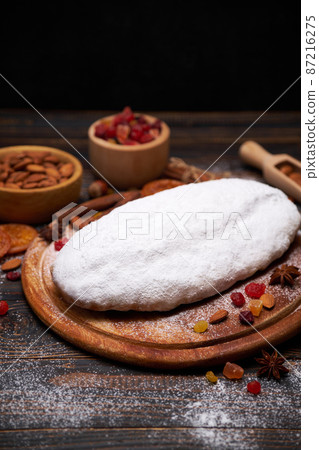 Traditional Christmas stollen cake recipe with ingredients on wooden background Traditional Christmas stollen cake recipe with ingredients on wooden background 87216275