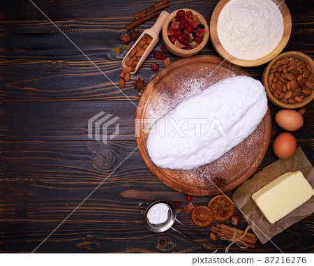 Traditional Christmas stollen cake recipe with ingredients isolated on wooden background Traditional Christmas stollen cake recipe with ingredients isolated on wooden background 87216276