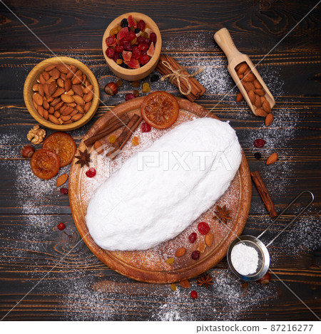 Traditional Christmas stollen cake recipe with ingredients on wooden background Traditional Christmas stollen cake recipe with ingredients on wooden background 87216277