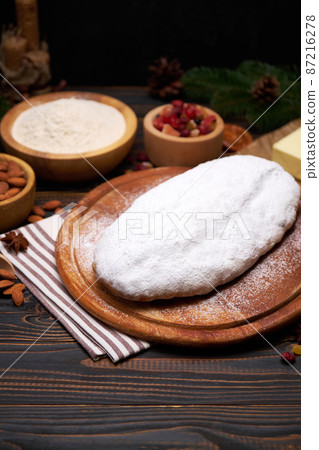 Traditional Christmas stollen cake recipe with ingredients isolated on wooden background Traditional Christmas stollen cake recipe with ingredients isolated on wooden background 87216278
