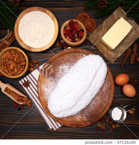 Traditional Christmas stollen cake recipe with ingredients isolated on wooden background Traditional Christmas stollen cake recipe with ingredients isolated on wooden background 87216280