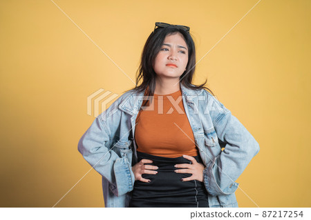 Young asian woman holding stomach when stomach is troubled 87217254