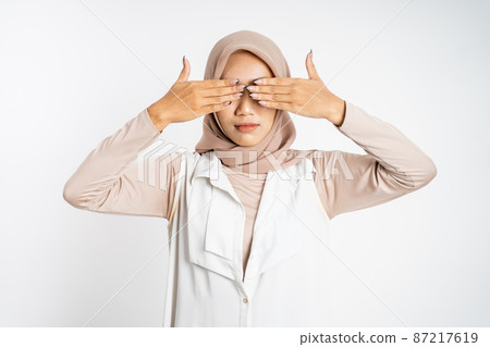 asian muslim woman closing eyes with both palms concept 87217619