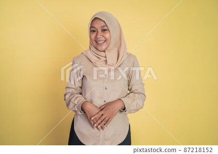 Asian woman in hijab smiling while looking at camera Asian woman in hijab smiling while looking at camera 87218152