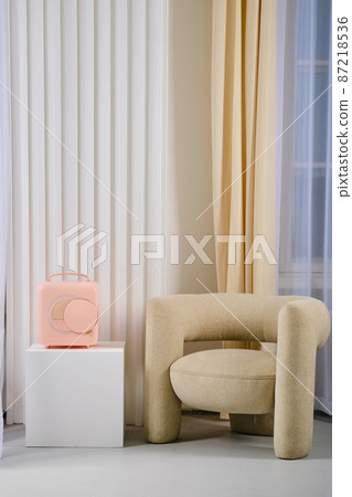 Mobile mini refrigerator near cozy armchair, portable fridge Mobile mini refrigerator near cozy armchair, portable fridge 87218536