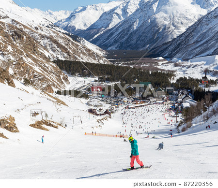 AZAU, RUSSIA - FERUARY 22: A lot of people skiing at Elbrus mountain, on February 22, 2015, Azau, Russia. 87220356