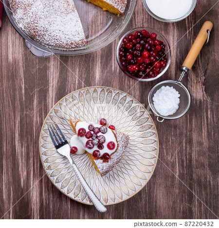 Piece of Swedish saffron Kladdkaka pie with white chocolate, whipping cream and cranberry, square Piece of Swedish saffron Kladdkaka pie with white chocolate, whipping cream and cranberry, square 87220432