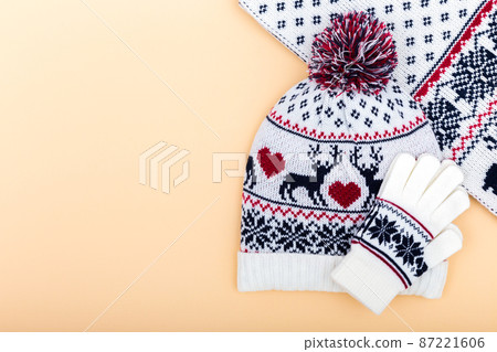 Gloves and worm woolen hat. winter set on orange background Gloves and worm woolen hat. winter set on orange background 87221606