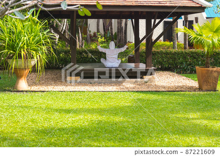 Woman in gazebo practicing yoga in Thailand in Asia Woman in gazebo practicing yoga in Thailand in Asia 87221609