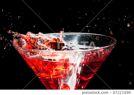 red splashing cocktail on black 87221890