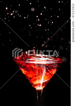 red splashing cocktail on black 87221912