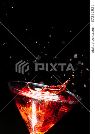 red splashing cocktail on black 87221923