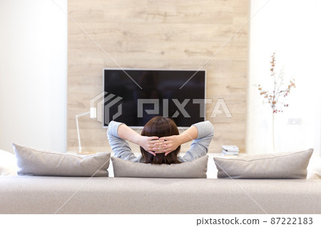 Young woman watching TV in the room Young woman watching TV in the room 87222183