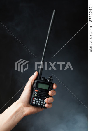 professional walkie-talkie radio in hand in smoke professional walkie-talkie radio in hand in smoke 87222494