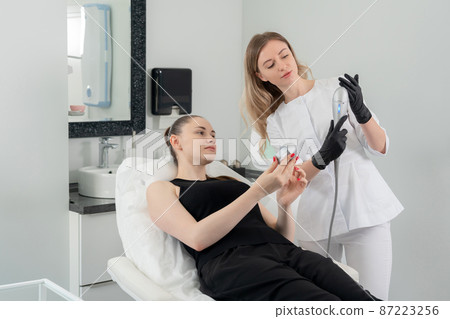 Young woman receiving laser treatment in cosmetology clinic 87223256