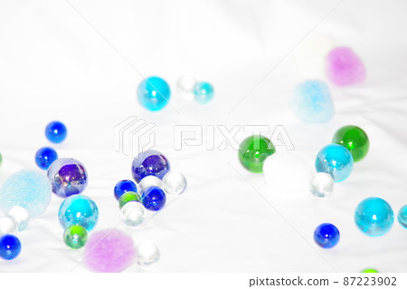 Colorful marbles and cotton balls 87223902