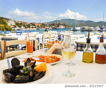 Seafood dinner in greek restaurant on seaside in Greece Seafood dinner in greek restaurant on seaside in Greece 87223937