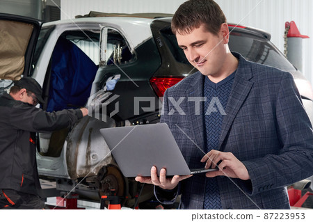 Auto mechanic and technician working in repair shop Auto mechanic and technician working in repair shop 87223953