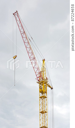 Construction crane tower against a blue sky. Construction crane tower against a blue sky. 87224658