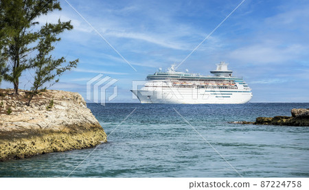 Cruise ship in Caribbean sea with island on foreground 87224758