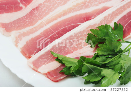pork brisket with parsley on a plate 87227852