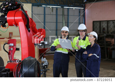 engineer checking control panel and teaching new Automatics robot arm and operating control machine in factory. engineer checking control panel and teaching new Automatics robot arm and operating control machine in factory. 87228051
