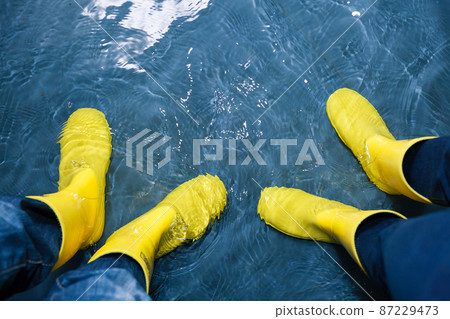 rubber boots in the water rubber boots in the water 87229473