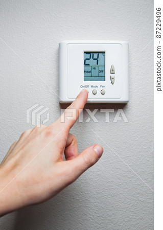 hand turning on digital climate control hand turning on digital climate control 87229496
