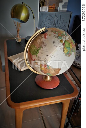 Researching with a desk globe 87229916